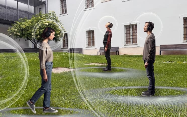 Visitors with headphones in the courtyard of the Volkskundemuseum Graz